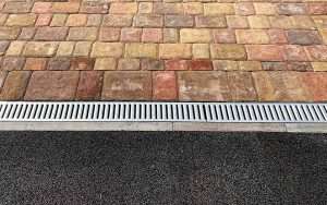 ACO drain on a Kingston driveway showing how debris and surface water can cause blockages